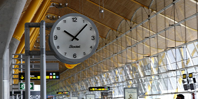Why is it essential to display an accurate time in an airport?
